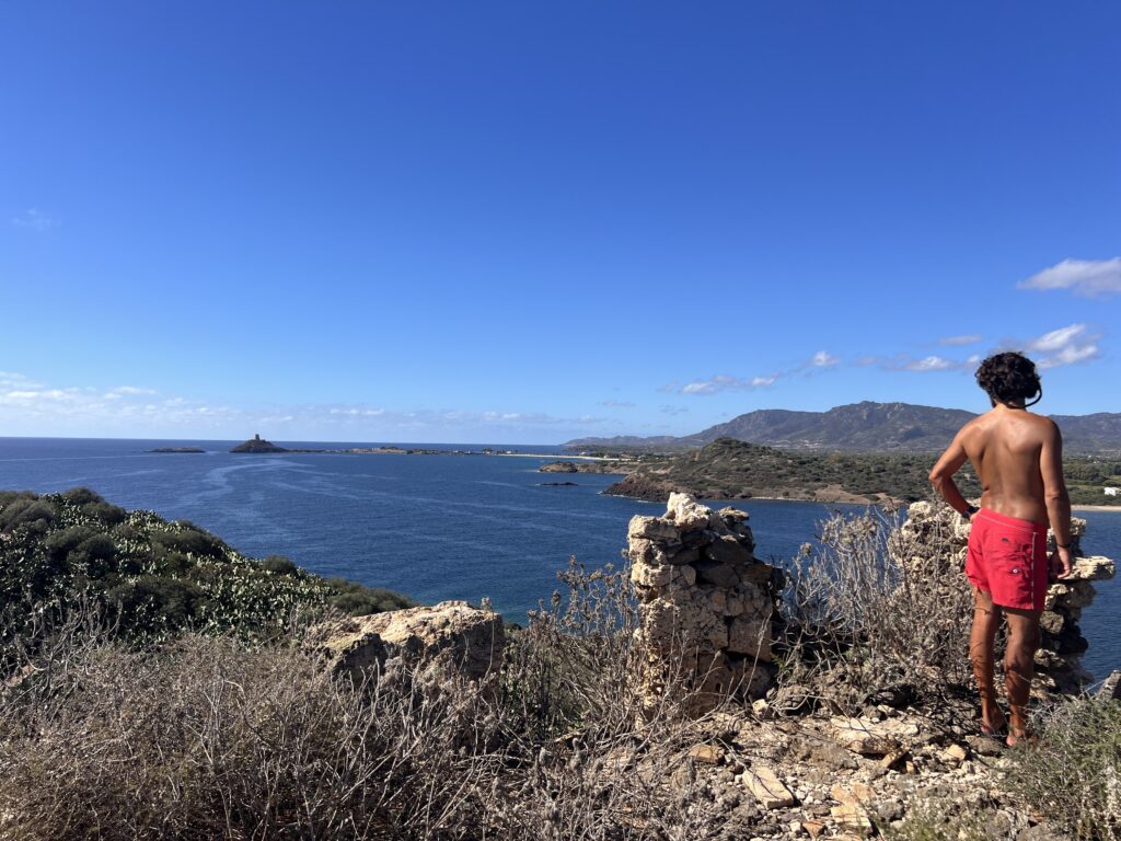 Man watching from the coast a beautiful bay and Isolotto Macario.